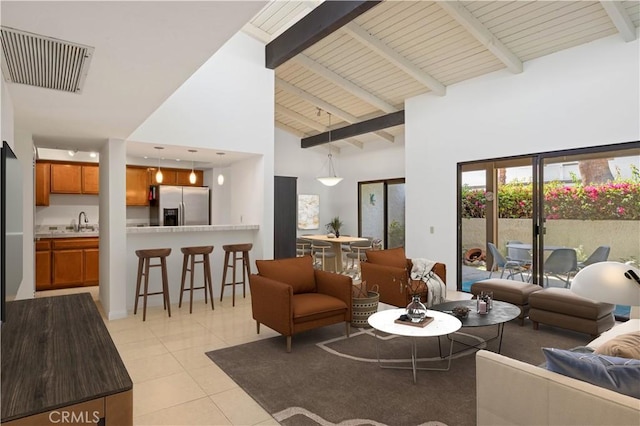 1150 E Palm Canyon Dr Unit 51, Palm Springs, CA 92264 - living room with high vaulted ceiling, light tile patterned flooring, and beamed ceiling