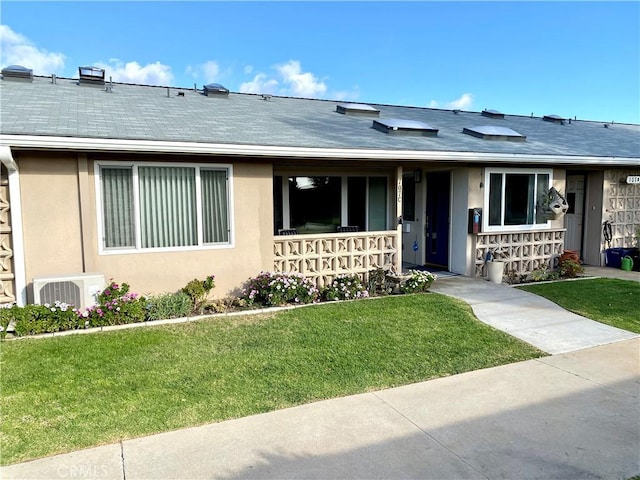 single story home with ac unit and a front yard