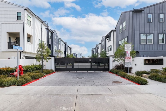 view of road with a residential view and a gate