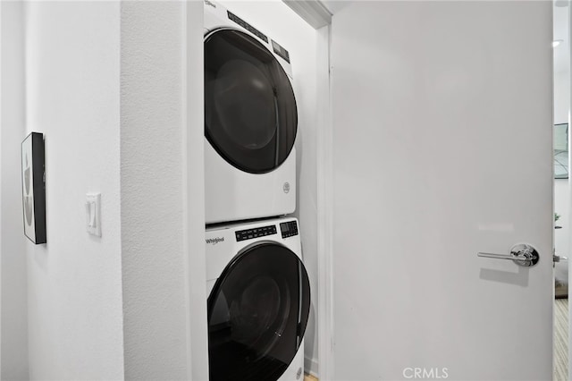 laundry area featuring stacked washer and clothes dryer