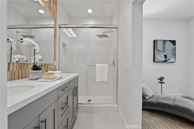 bathroom featuring tile patterned floors, vanity, and walk in shower