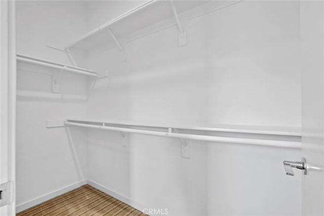 spacious closet with light hardwood / wood-style floors