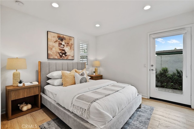 bedroom featuring light hardwood / wood-style flooring and access to exterior