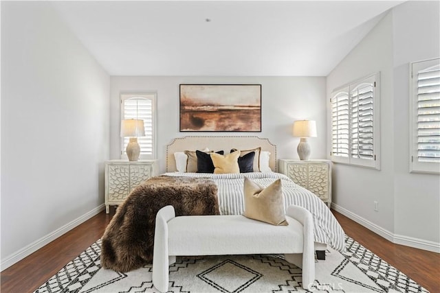 bedroom with hardwood / wood-style flooring and lofted ceiling