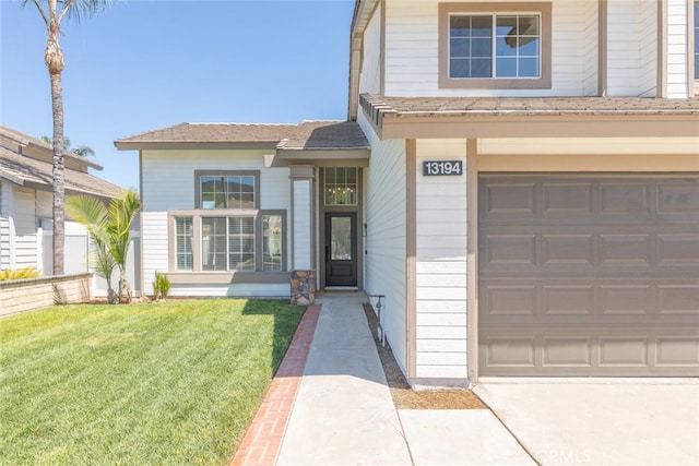 view of front of home with a front yard and a garage