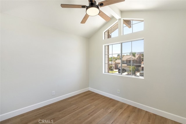 empty room featuring ceiling fan, vaulted ceiling with beams, and wood-type flooring