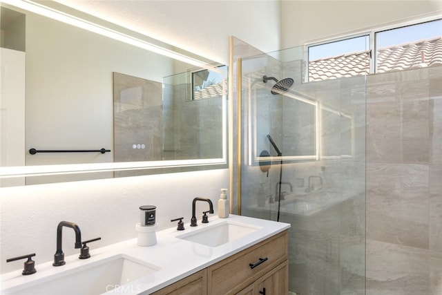 bathroom with vanity and a shower with door