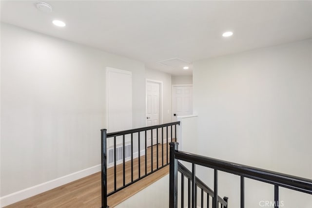 corridor with light hardwood / wood-style floors