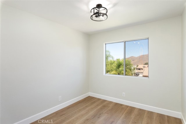 empty room with hardwood / wood-style flooring