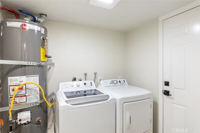 laundry area featuring water heater and separate washer and dryer