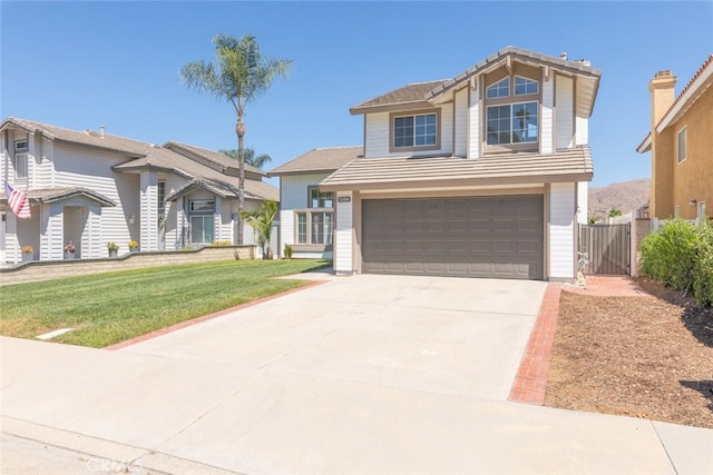 view of front of house featuring a front lawn and a garage