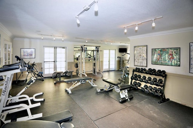 gym with rail lighting, ornamental molding, and french doors