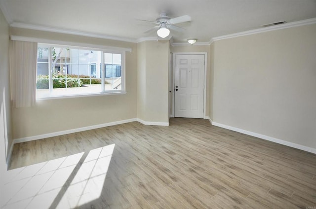 spare room featuring wood-type flooring, ceiling fan, and crown molding