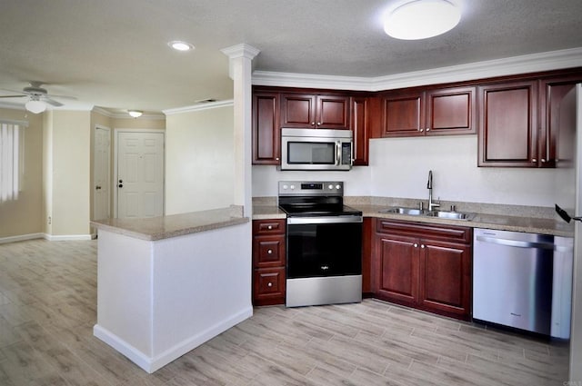 kitchen with sink, crown molding, stainless steel appliances, and light hardwood / wood-style floors