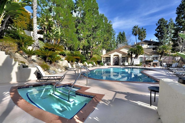 view of pool with a patio area and a community hot tub