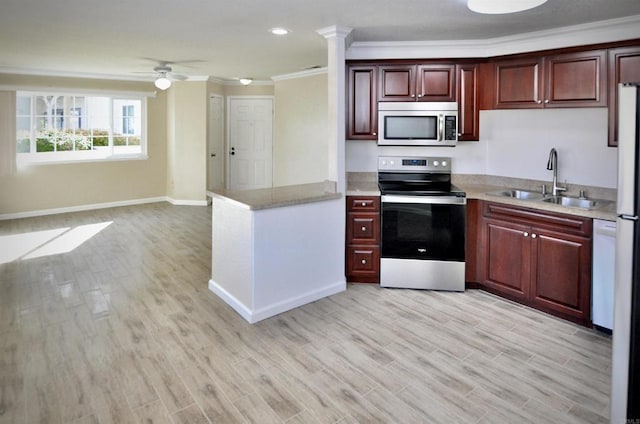 kitchen with sink, ornamental molding, appliances with stainless steel finishes, and light wood-type flooring