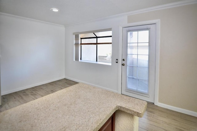 doorway featuring light hardwood / wood-style floors and ornamental molding