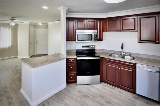 kitchen featuring light hardwood / wood-style floors, appliances with stainless steel finishes, sink, and ornamental molding