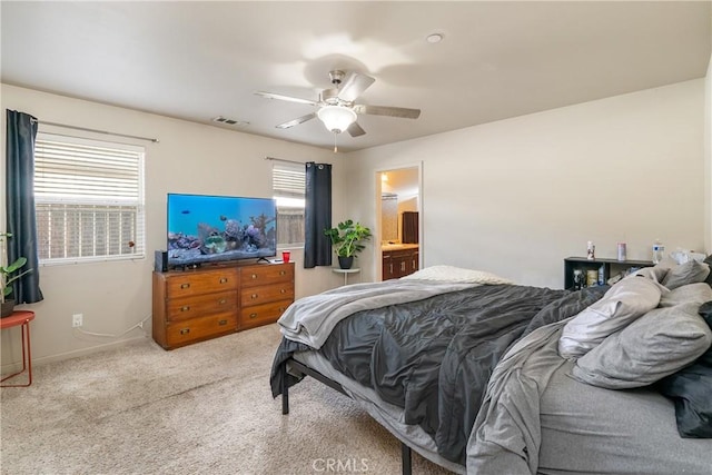 carpeted bedroom featuring connected bathroom and ceiling fan