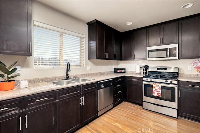 kitchen with light hardwood / wood-style flooring, sink, stainless steel appliances, and dark brown cabinetry