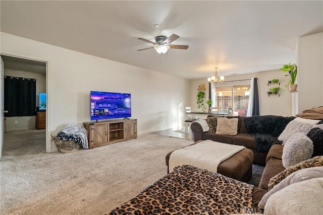 carpeted living room with ceiling fan with notable chandelier