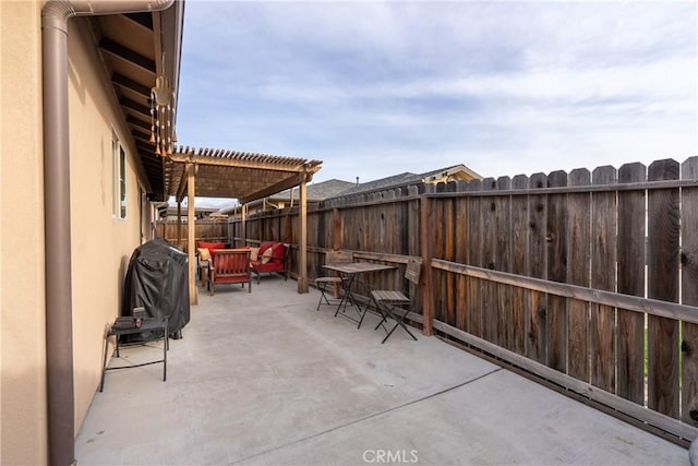 view of patio featuring grilling area and a pergola