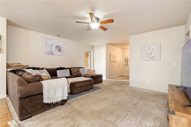 living room with light carpet and ceiling fan