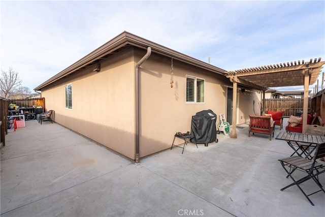 view of property exterior with a patio, outdoor lounge area, and a pergola