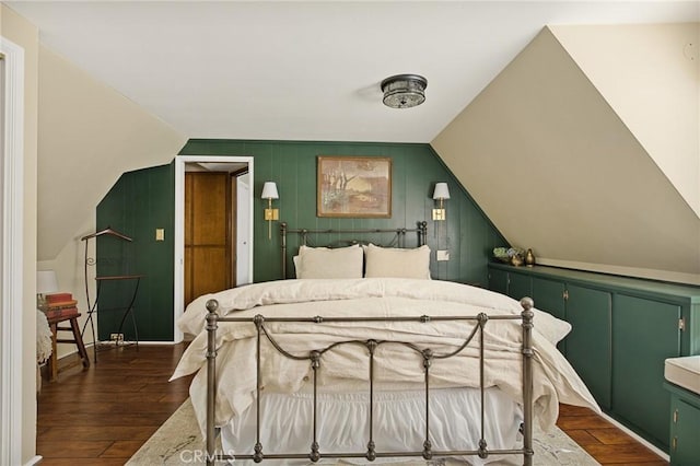 bedroom with lofted ceiling and dark hardwood / wood-style flooring