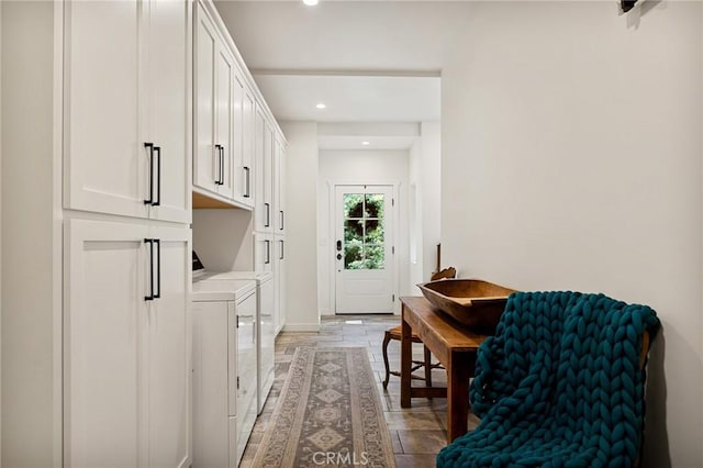 washroom featuring washer and dryer and cabinets