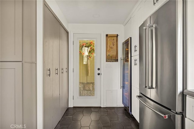 doorway with dark tile patterned flooring