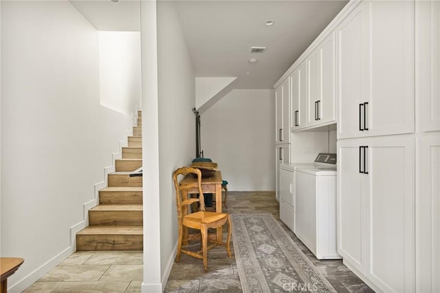 laundry area featuring washing machine and dryer and cabinets