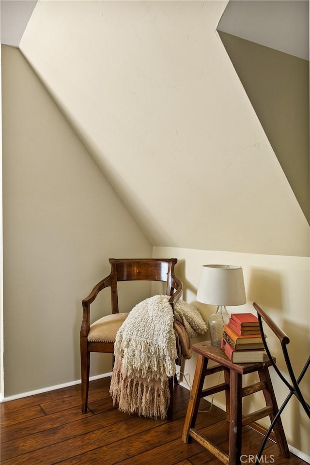 bedroom with dark wood-type flooring and lofted ceiling