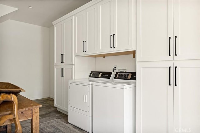 washroom with cabinets, hardwood / wood-style flooring, and washing machine and clothes dryer