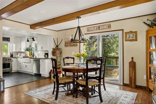 dining space featuring beam ceiling, dark wood-type flooring, and a chandelier