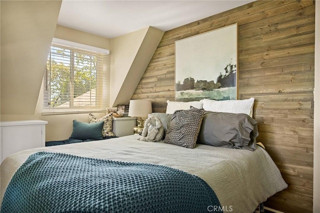 bedroom with wood walls