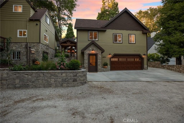 view of front of property featuring a garage and a gazebo