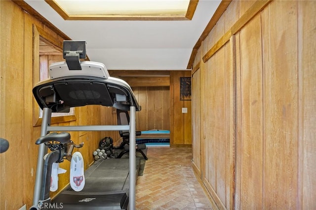 exercise area featuring wooden walls