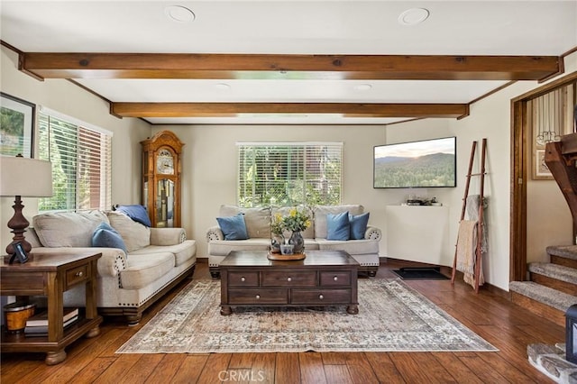 living room featuring beam ceiling and dark hardwood / wood-style floors