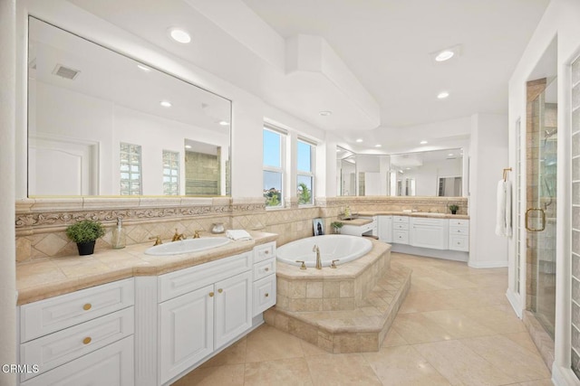 bathroom with tile patterned floors, vanity, tasteful backsplash, and independent shower and bath