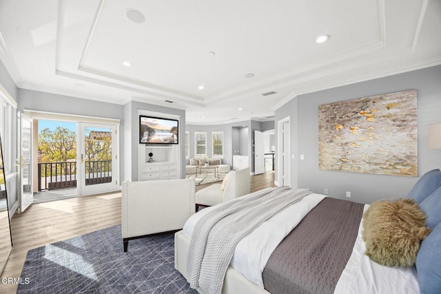 bedroom with a tray ceiling, access to exterior, ornamental molding, and dark hardwood / wood-style floors