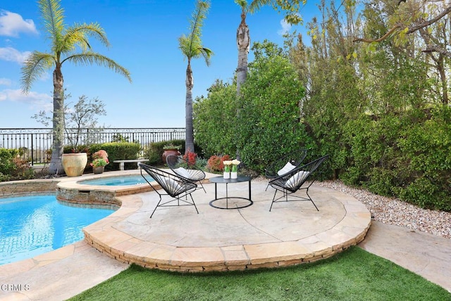 view of pool with a patio and an in ground hot tub