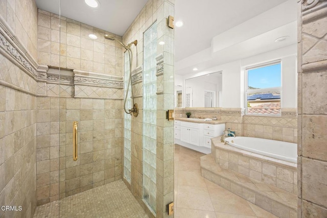 bathroom featuring vanity, tile patterned flooring, and shower with separate bathtub