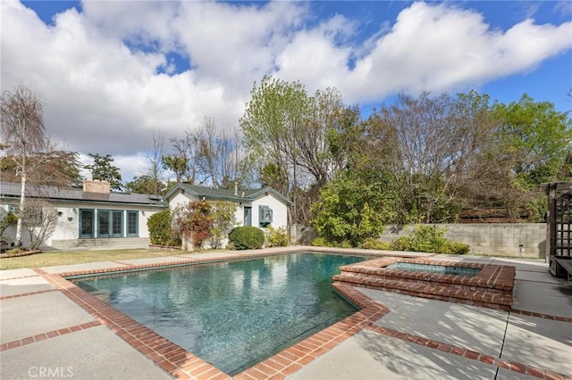 view of pool with a patio and an in ground hot tub