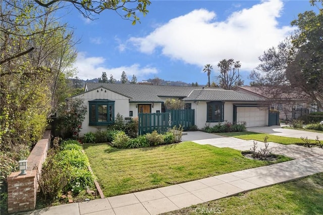 ranch-style house featuring a front yard and a garage