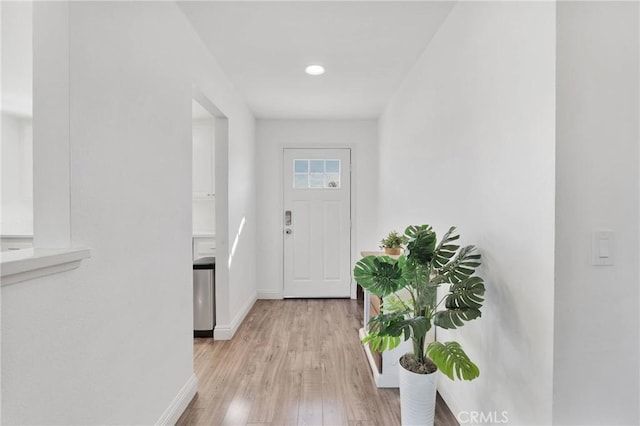 doorway featuring light wood-style floors, recessed lighting, and baseboards