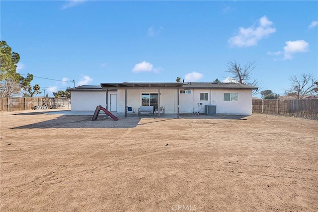 rear view of property with a patio, a fenced backyard, and cooling unit