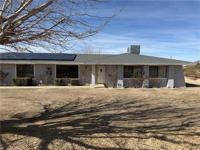 ranch-style house with solar panels