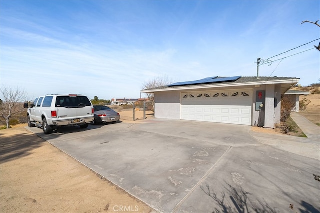 exterior space with solar panels and a garage