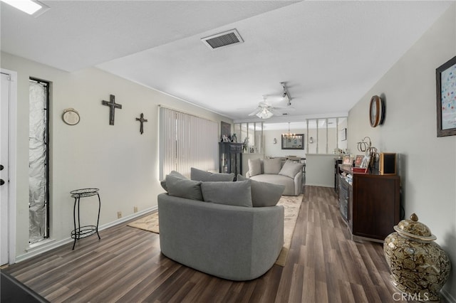 living room with a textured ceiling, dark hardwood / wood-style floors, and a wealth of natural light